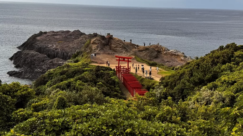 Red torii gate by the sea